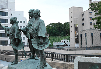 黄門様一行の右奥の緑が水戸城址。